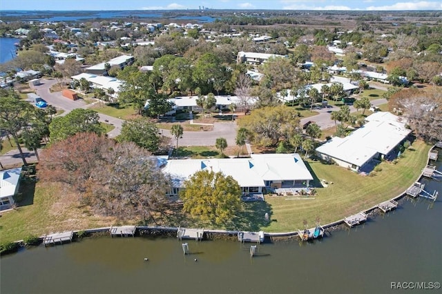 drone / aerial view with a water view and a residential view