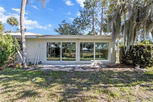 rear view of property with a yard and a patio