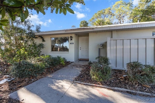 doorway to property with stucco siding