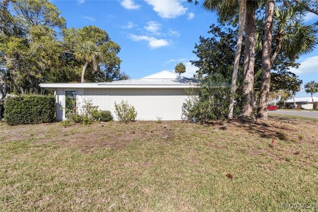 view of home's exterior with a lawn