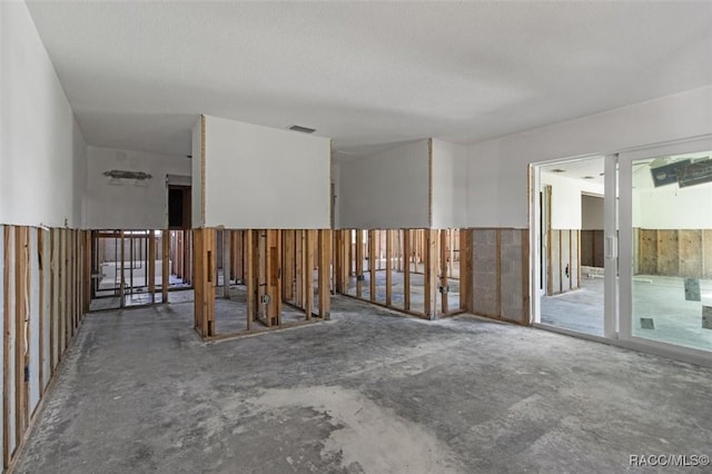 spare room with visible vents and unfinished concrete floors