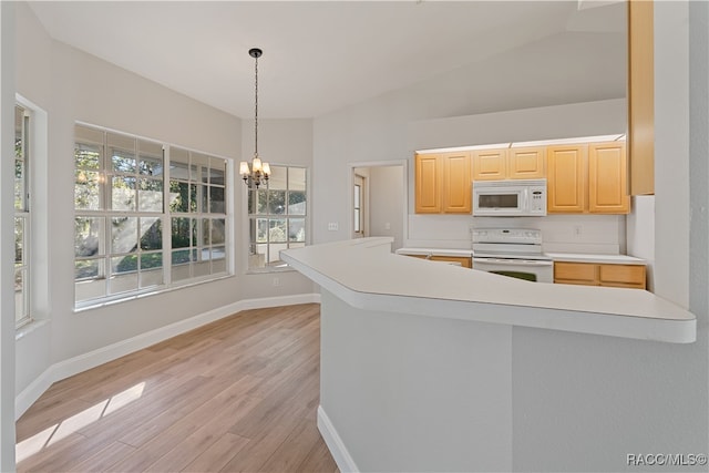 kitchen with kitchen peninsula, white appliances, vaulted ceiling, light brown cabinets, and light hardwood / wood-style flooring