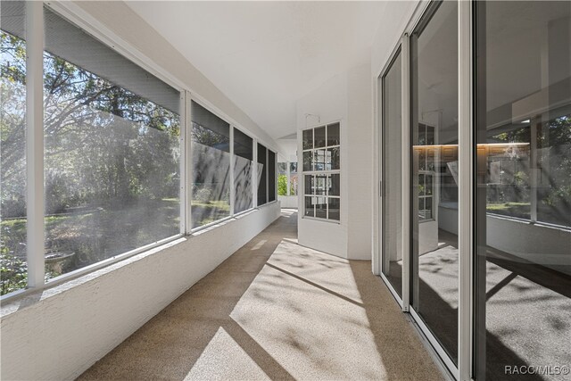 sunroom / solarium featuring lofted ceiling