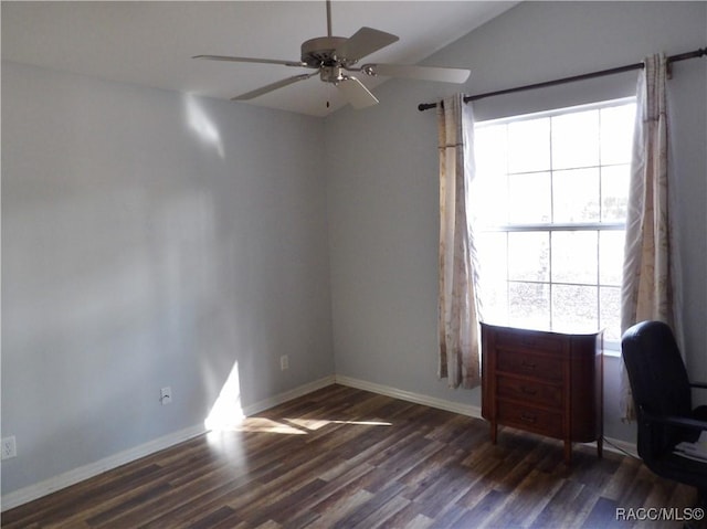 unfurnished office featuring dark wood-type flooring, ceiling fan, and vaulted ceiling