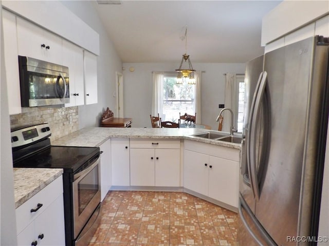 kitchen with white cabinetry, appliances with stainless steel finishes, kitchen peninsula, and sink