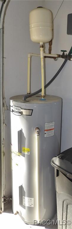 utility room featuring water heater