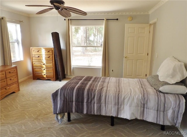 bedroom with crown molding, ceiling fan, and light carpet