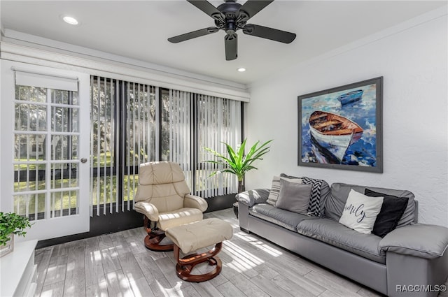 living room featuring ceiling fan and light wood-type flooring