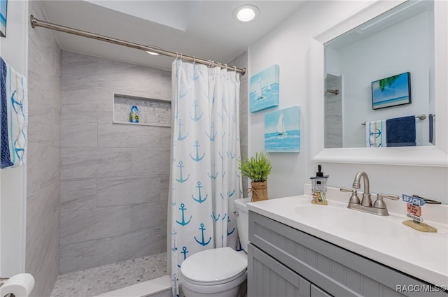 bathroom with curtained shower, vanity, and toilet