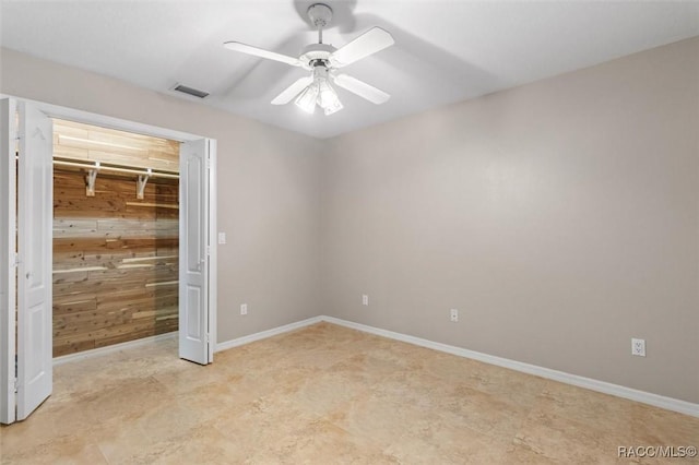 4105 W Tomahawk Dr, Beverly Hills, FL 34465 - unfurnished bedroom with wooden walls, a ceiling fan, and a closet