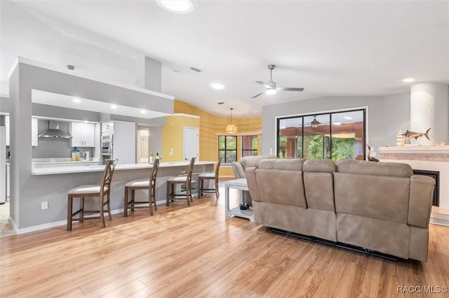 4105 W Tomahawk Dr, Beverly Hills, FL 34465 - living area featuring a ceiling fan, vaulted ceiling, light wood-type flooring, recessed lighting, and a fireplace