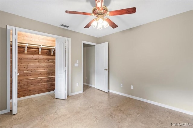 4105 W Tomahawk Dr, Beverly Hills, FL 34465 - unfurnished bedroom featuring wooden walls, concrete floors, and ceiling fan