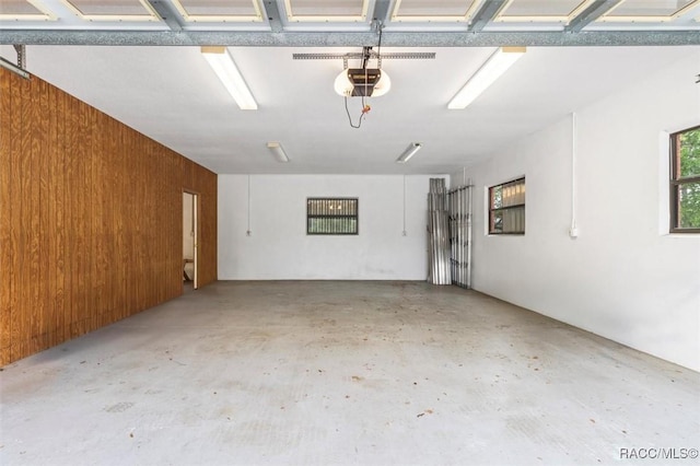 4105 W Tomahawk Dr, Beverly Hills, FL 34465 - garage with a garage door opener and wood walls