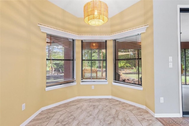 4105 W Tomahawk Dr, Beverly Hills, FL 34465 - unfurnished room with plenty of natural light and a chandelier