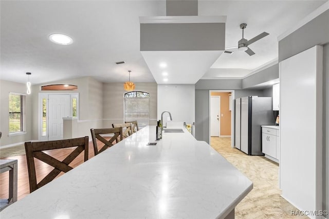 4105 W Tomahawk Dr, Beverly Hills, FL 34465 - kitchen featuring freestanding refrigerator, white cabinets, ceiling fan, plenty of natural light, and recessed lighting