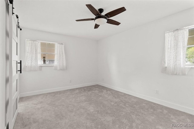 3874 N Timucua Pt, Crystal River, FL 34428 - carpeted spare room with a barn door and ceiling fan