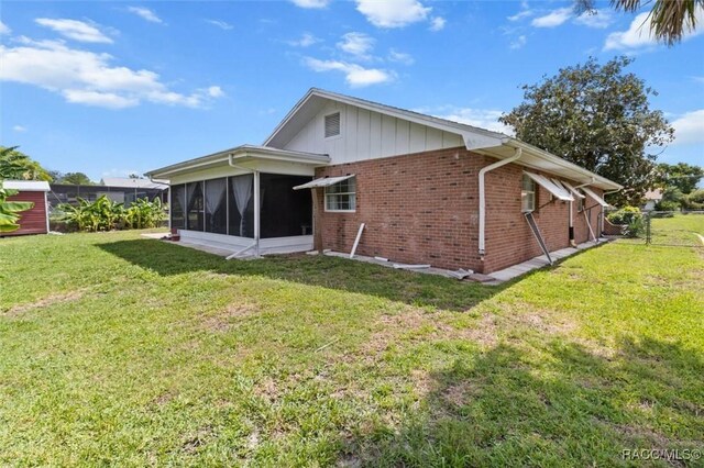 3874 N Timucua Pt, Crystal River, FL 34428 - back of property with a sunroom and brick siding