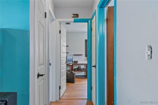 208 S Adams St, Beverly Hills, FL 34465 - hallway featuring light wood-type flooring and a textured ceiling
