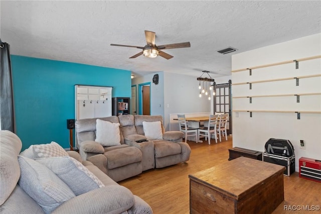 208 S Adams St, Beverly Hills, FL 34465 - living area featuring wood finished floors, a ceiling fan, and a textured ceiling