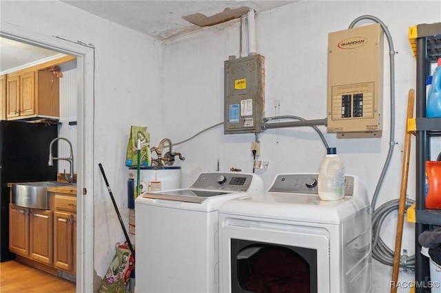 208 S Adams St, Beverly Hills, FL 34465 - laundry room featuring washer and dryer, electric panel, and light wood finished floors