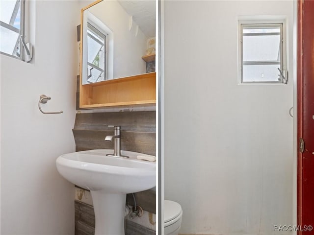 208 S Adams St, Beverly Hills, FL 34465 - bathroom featuring toilet and tasteful backsplash