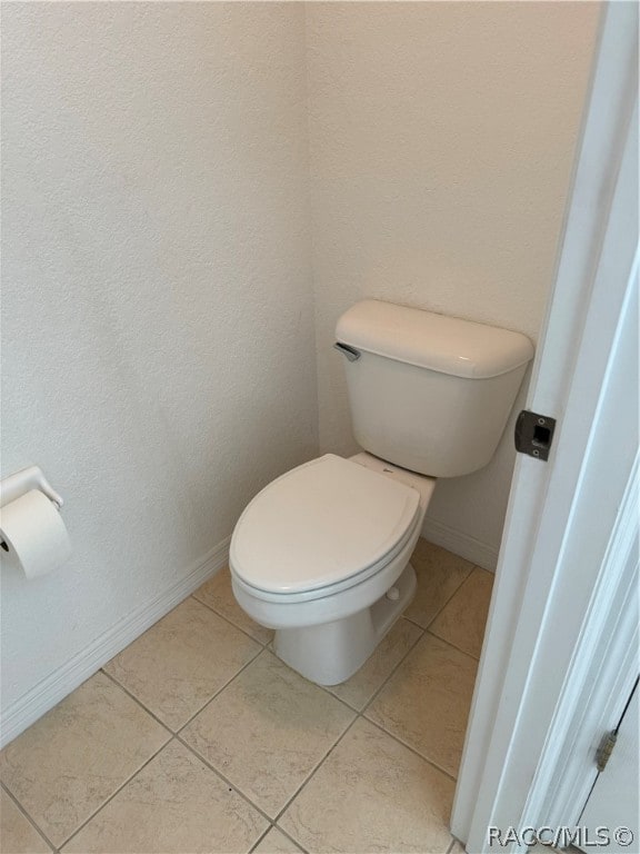 bathroom with tile patterned flooring and toilet