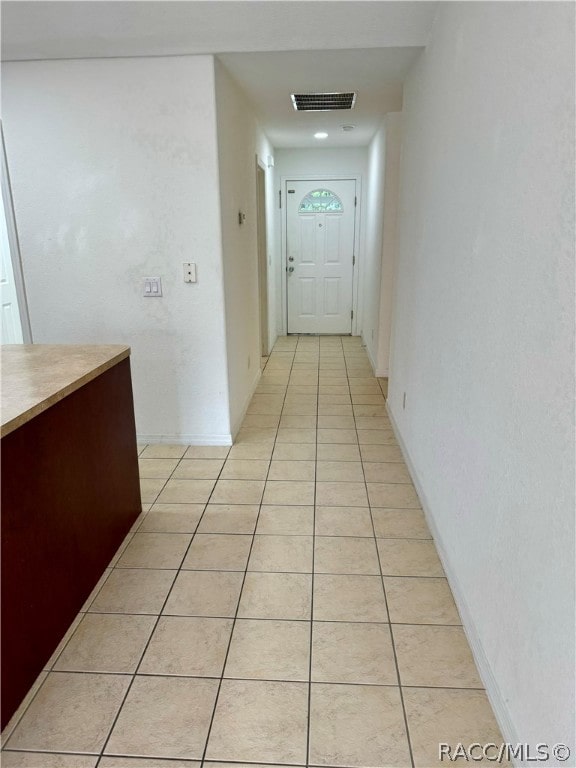 corridor featuring light tile patterned floors