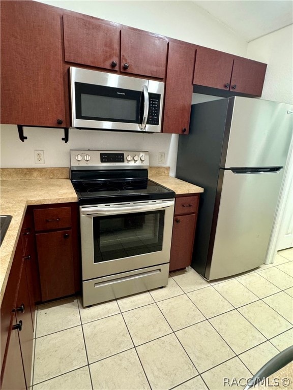 kitchen featuring appliances with stainless steel finishes and light tile patterned floors