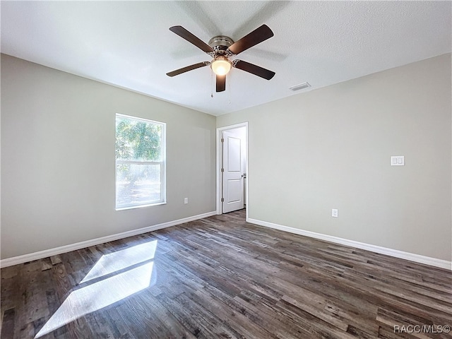 spare room featuring ceiling fan, dark hardwood / wood-style floors, and a textured ceiling