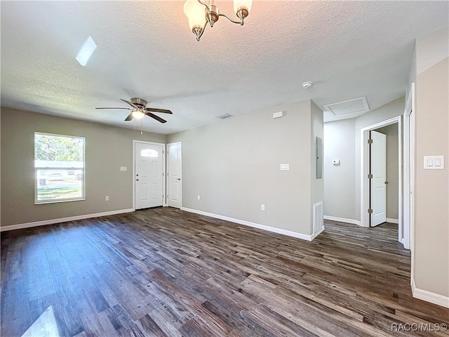 interior space with dark hardwood / wood-style floors, ceiling fan with notable chandelier, and a textured ceiling