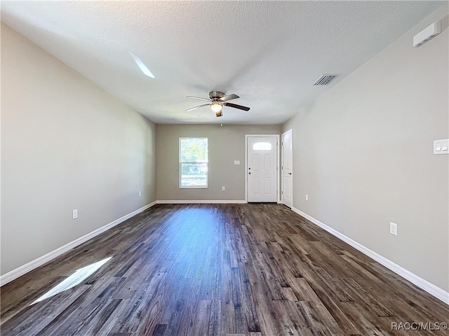 interior space featuring ceiling fan, dark hardwood / wood-style floors, and a textured ceiling