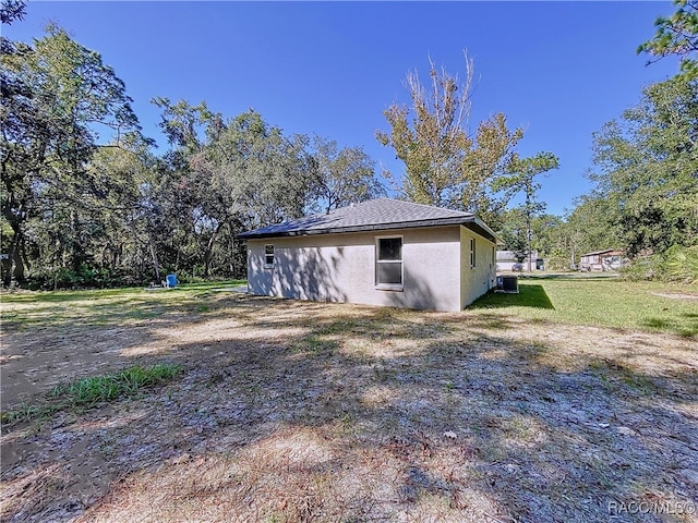 view of home's exterior featuring cooling unit and a yard