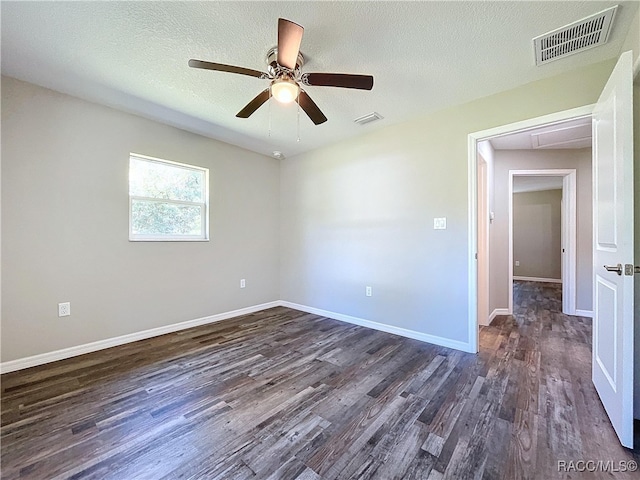 unfurnished room featuring ceiling fan, a textured ceiling, and dark hardwood / wood-style flooring