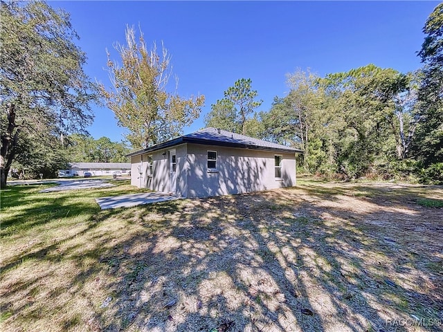 view of side of home with a lawn