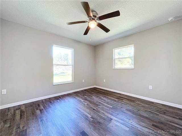 unfurnished room featuring ceiling fan, a textured ceiling, and dark hardwood / wood-style floors