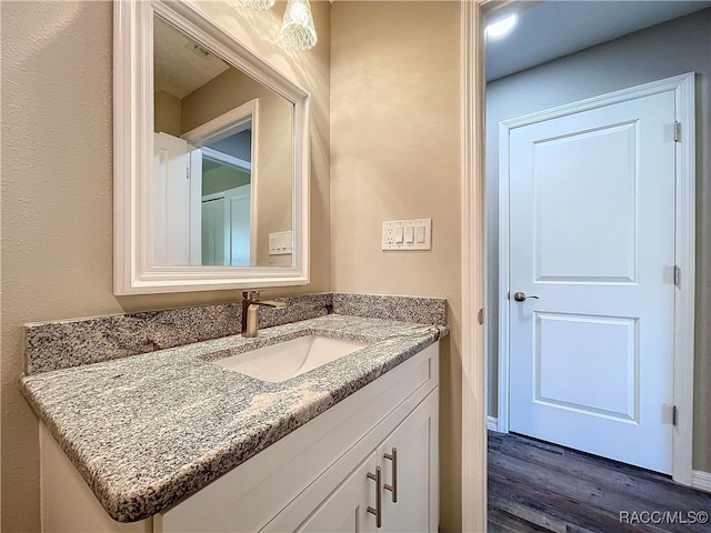 bathroom featuring vanity and wood-type flooring