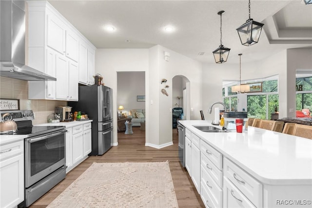2056 W Learwood Pl, Beverly Hills, FL 34465 - kitchen featuring stainless steel appliances, wall chimney range hood, a sink, decorative backsplash, and light countertops