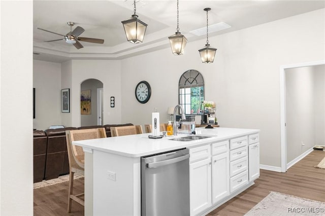 2056 W Learwood Pl, Beverly Hills, FL 34465 - kitchen featuring dishwasher, a sink, arched walkways, ceiling fan, and light wood-type flooring