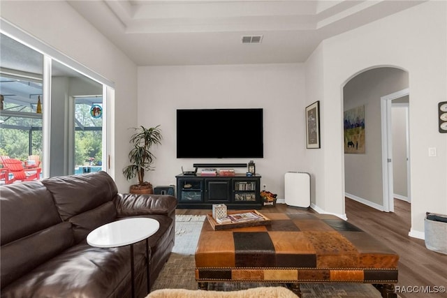 2056 W Learwood Pl, Beverly Hills, FL 34465 - living room with arched walkways, wood finished floors, baseboards, and a raised ceiling