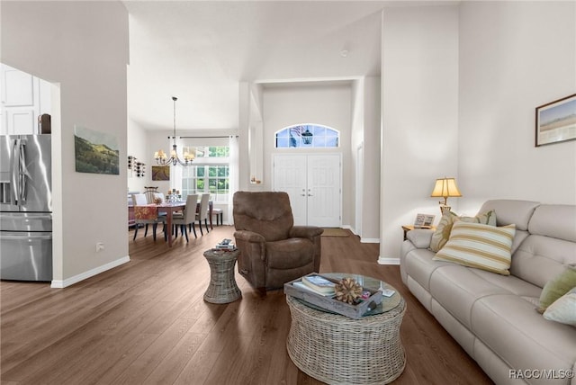 2056 W Learwood Pl, Beverly Hills, FL 34465 - living area with wood finished floors, a chandelier, baseboards, and a high ceiling