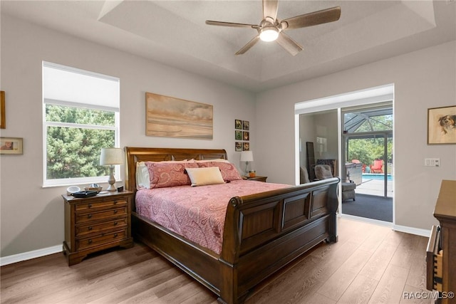 2056 W Learwood Pl, Beverly Hills, FL 34465 - bedroom featuring a raised ceiling, light wood finished floors, access to exterior, baseboards, and a ceiling fan
