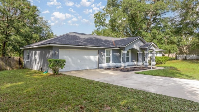 ranch-style home with a garage and a front lawn