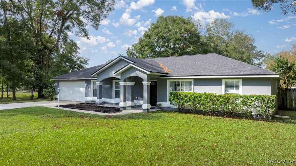 single story home with a garage and a front lawn