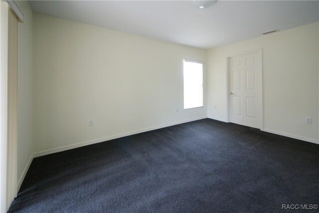 4450 E Windmill Dr Unit 106, 107, 206, 207, Inverness, FL 34453 - unfurnished bedroom featuring dark colored carpet and baseboards