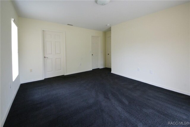 4450 E Windmill Dr Unit 106, 107, 206, 207, Inverness, FL 34453 - empty room featuring baseboards and dark colored carpet