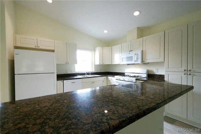 4450 E Windmill Dr Unit 106, 107, 206, 207, Inverness, FL 34453 - kitchen with white appliances, lofted ceiling, white cabinets, a sink, and a peninsula