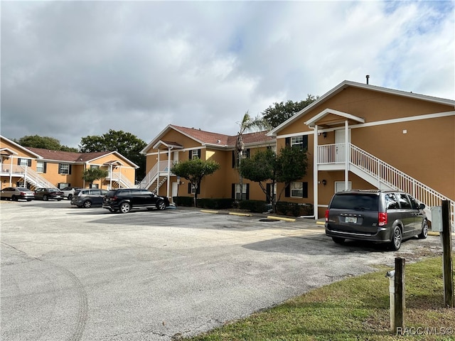 4450 E Windmill Dr Unit 106, 107, 206, 207, Inverness, FL 34453 - view of property with stairs and uncovered parking
