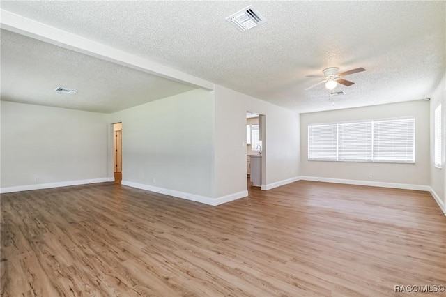 unfurnished room with visible vents, baseboards, light wood-type flooring, and ceiling fan