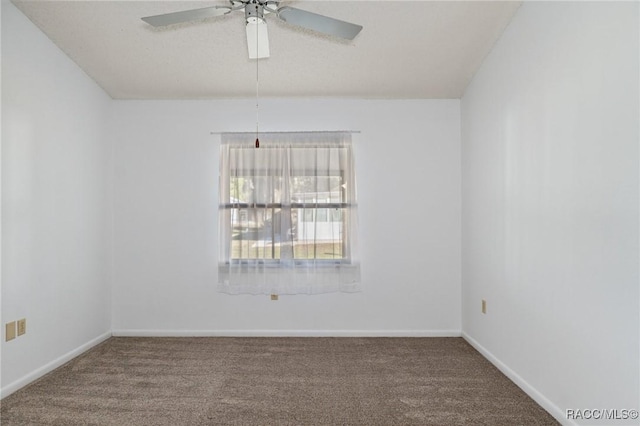 unfurnished room with ceiling fan and carpet floors