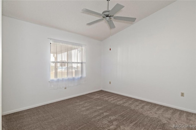 carpeted empty room featuring ceiling fan and vaulted ceiling